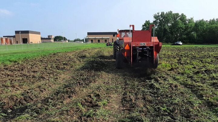 tractor applying biochar to field